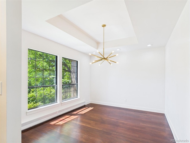 3957 S Peach Way, Denver, CO 80237 - empty room with a chandelier, dark wood-type flooring, recessed lighting, and a raised ceiling