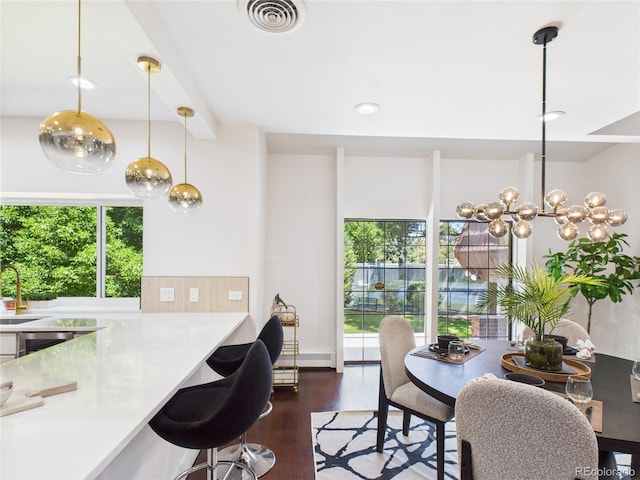 3957 S Peach Way, Denver, CO 80237 - dining space featuring wood finished floors, recessed lighting, wine cooler, and a chandelier