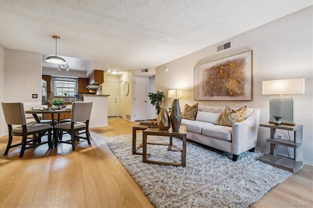 2710 E Otero Pl Unit 6, Centennial, CO 80122 - living area with light wood-style floors and a textured ceiling