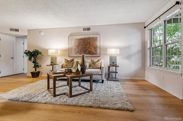 2710 E Otero Pl Unit 6, Centennial, CO 80122 - living room featuring wood finished floors and a textured ceiling