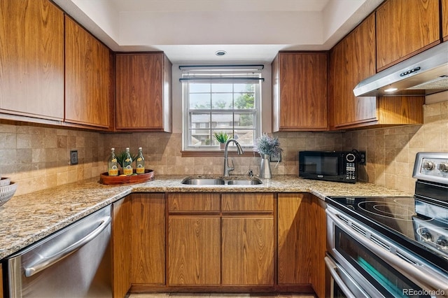 2710 E Otero Pl Unit 6, Centennial, CO 80122 - kitchen with appliances with stainless steel finishes and brown cabinetry