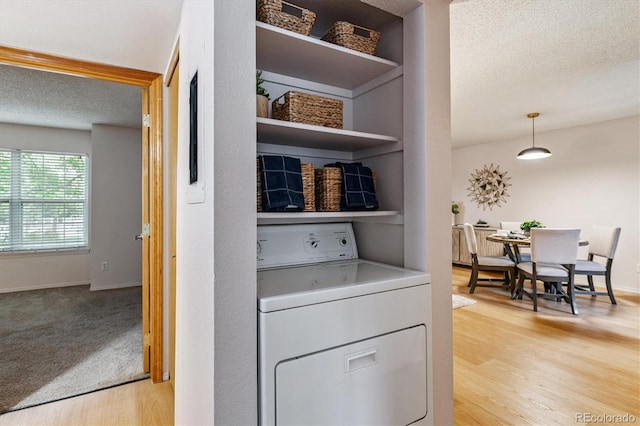 2710 E Otero Pl Unit 6, Centennial, CO 80122 - laundry room with washer / clothes dryer, light wood-style floors, and a textured ceiling