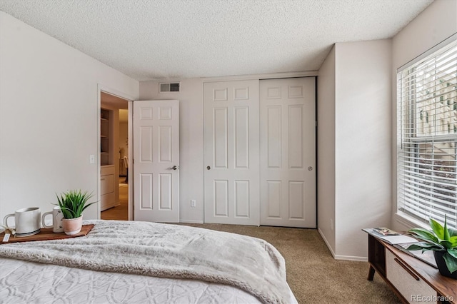 2710 E Otero Pl Unit 6, Centennial, CO 80122 - bedroom with a textured ceiling, carpet, and a closet