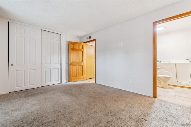2710 E Otero Pl Unit 6, Centennial, CO 80122 - unfurnished bedroom featuring carpet, a closet, and ensuite bathroom