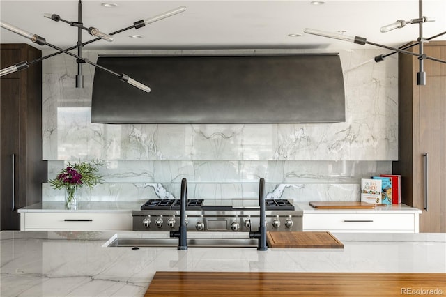 kitchen featuring white cabinetry, stainless steel range, and exhaust hood