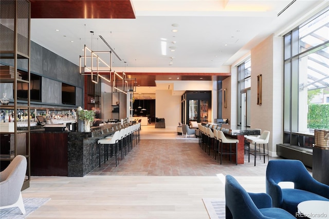 interior space featuring a breakfast bar and light hardwood / wood-style flooring