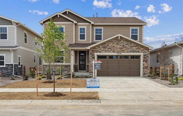 24748 E 40th Ave, Aurora, CO 80019 - craftsman-style house featuring stone siding, concrete driveway, fence, and an attached garage