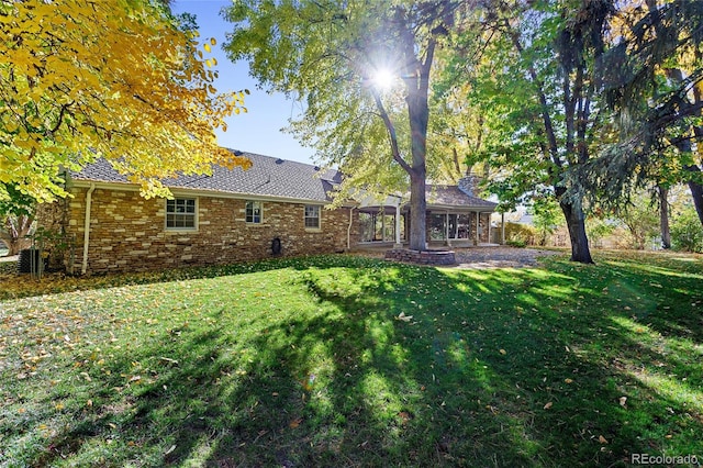 rear view of house with a lawn