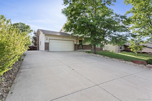 874 Mercury Cir, Lone Tree, CO 80124 - view of front of home with a garage, a front yard, driveway, and brick siding