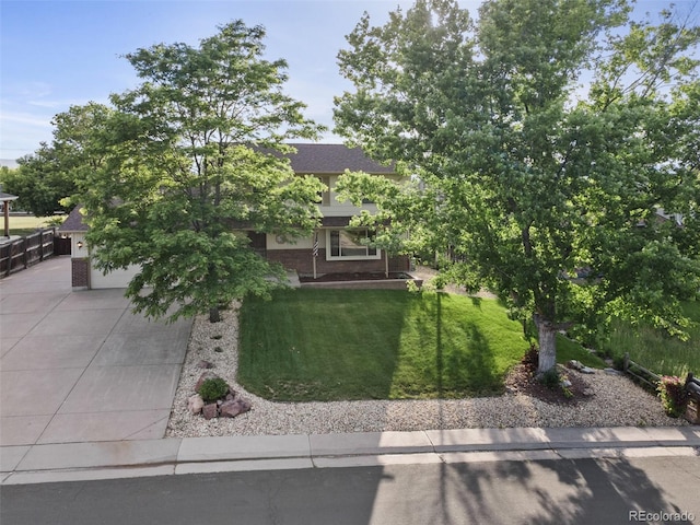 874 Mercury Cir, Lone Tree, CO 80124 - obstructed view of property with driveway, a front yard, and brick siding