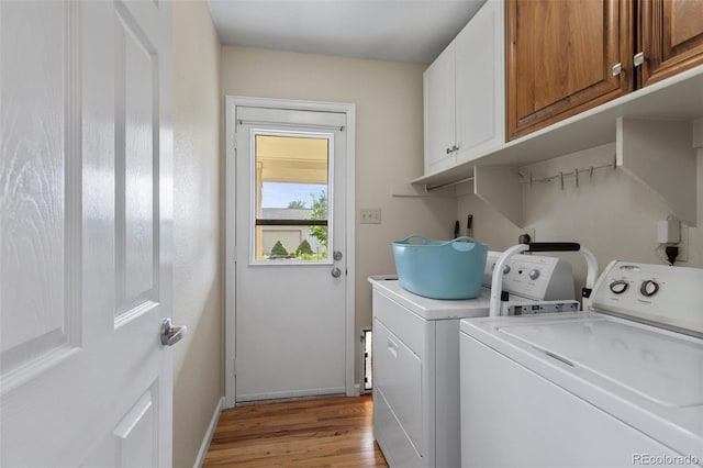 874 Mercury Cir, Lone Tree, CO 80124 - laundry room featuring washer and clothes dryer, cabinet space, and light wood-type flooring