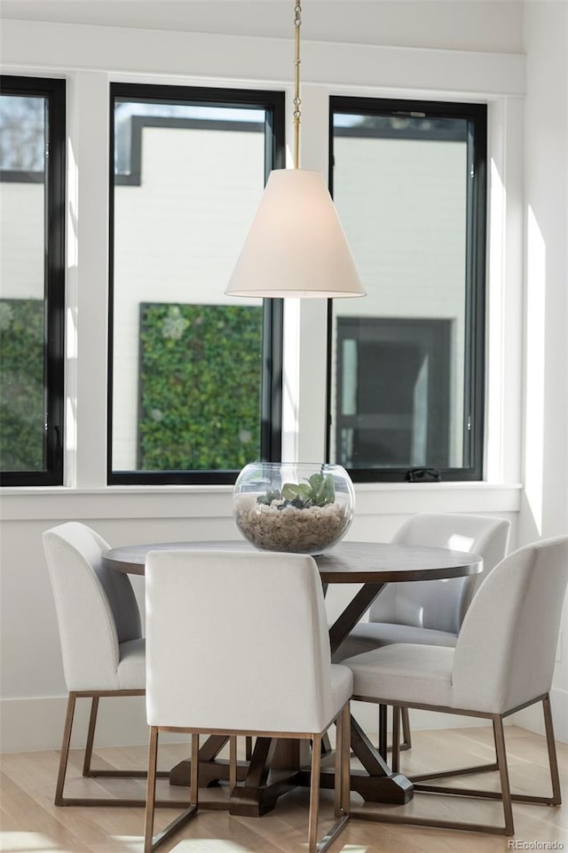 dining area with a wealth of natural light and wood finished floors