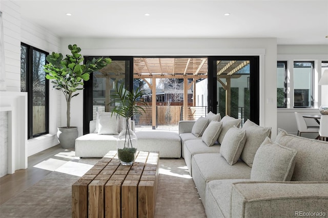 living area with wood finished floors, a wealth of natural light, and recessed lighting