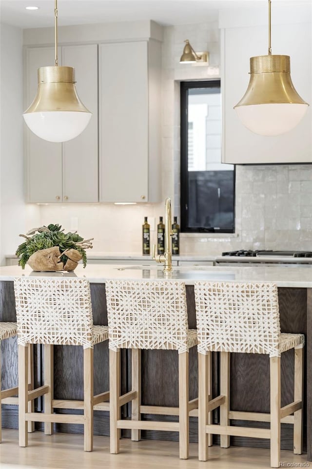 kitchen featuring white cabinetry, light countertops, and pendant lighting