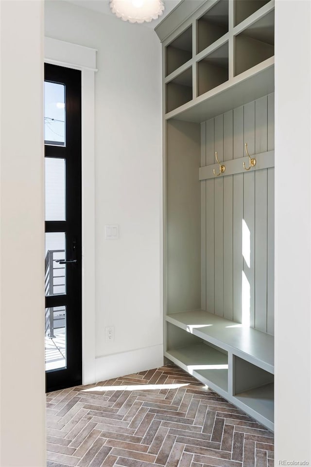 mudroom featuring brick floor and plenty of natural light