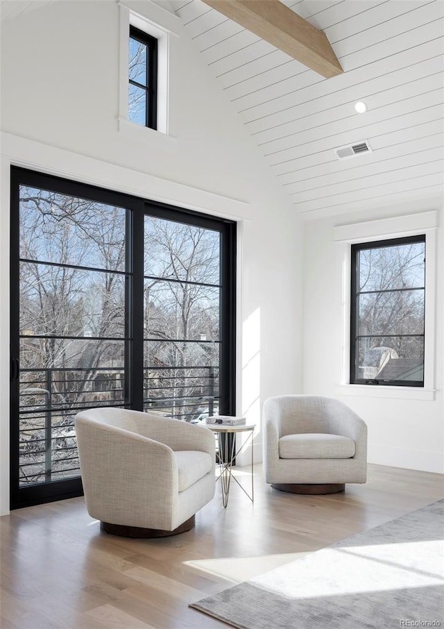 sitting room featuring light wood-style floors, plenty of natural light, and visible vents