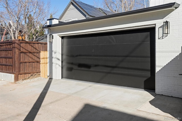 garage with driveway and fence