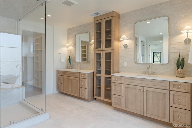 bathroom with two vanities, visible vents, a sink, and a shower stall