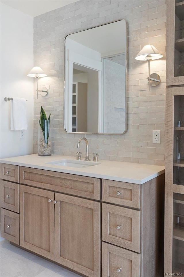 bathroom with tasteful backsplash and vanity