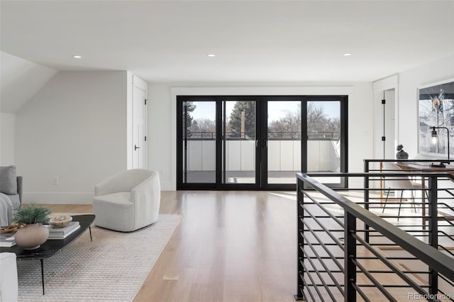 interior space with recessed lighting, wood finished floors, a wealth of natural light, and baseboards