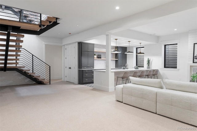 living room featuring light carpet, stairway, baseboards, and recessed lighting