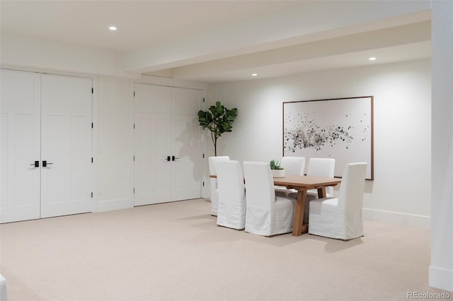 unfurnished dining area featuring baseboards, recessed lighting, and light colored carpet