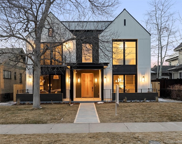 view of front facade featuring board and batten siding and fence