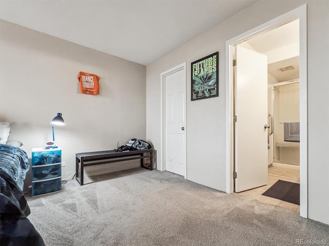 carpeted bedroom with ensuite bathroom
