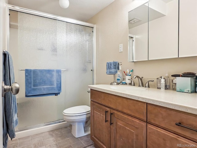 full bathroom with a stall shower, toilet, and vanity