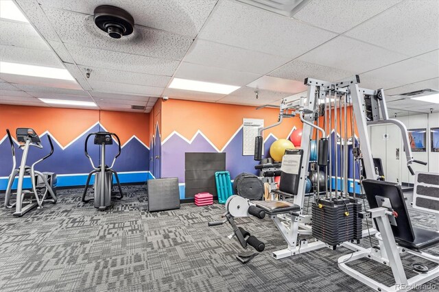 workout area with a drop ceiling and carpet floors