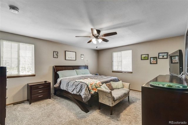 7394 S Field Ct, Littleton, CO 80128 - bedroom with multiple windows, light colored carpet, and a ceiling fan