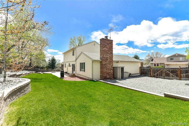7394 S Field Ct, Littleton, CO 80128 - rear view of property with a patio, a fenced backyard, and a chimney