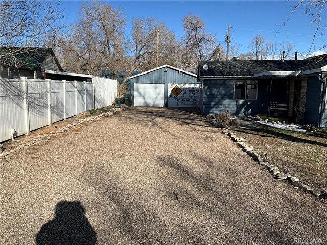 104 Tyranosaurus Trl, Dinosaur, CO 81610 - view of yard featuring a detached garage, driveway, and an outbuilding