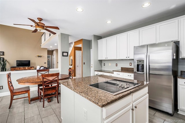 5774 S Genoa Ct, Aurora, CO 80015 - kitchen featuring stainless steel refrigerator with ice dispenser, black electric stovetop, ceiling fan, white cabinetry, and dark stone counters