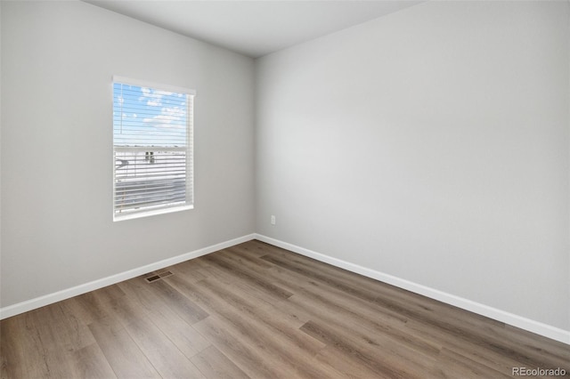 unfurnished room with hardwood / wood-style floors