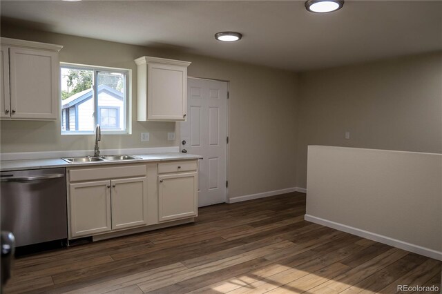 kitchen with dishwasher, sink, wood-type flooring, and white cabinetry