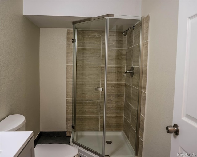 1511 E Routt St Ave, Pueblo, CO 81004 - bathroom featuring vanity, toilet, and a shower stall