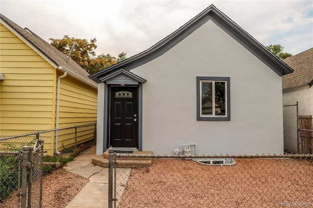 1511 E Routt St Ave, Pueblo, CO 81004 - entrance to property featuring fence, a shingled roof, and stucco siding