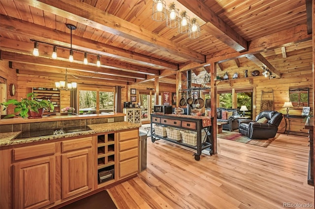 1673 Sinton Rd, Evergreen, CO 80439 - kitchen featuring a chandelier, track lighting, wood walls, wood ceiling with exposed beams, and open floor plan