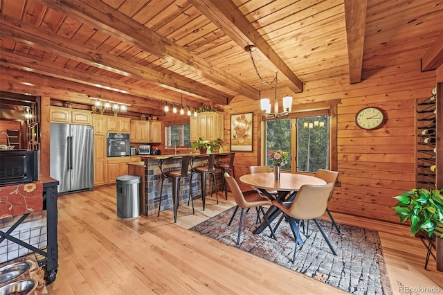1673 Sinton Rd, Evergreen, CO 80439 - dining room featuring a chandelier, light wood-type flooring, wood walls, and wooden ceiling with exposed beams