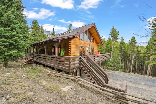 1673 Sinton Rd, Evergreen, CO 80439 - view of side of property featuring log exterior, a wooden deck, and stairway