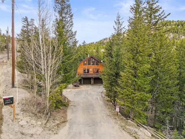 1673 Sinton Rd, Evergreen, CO 80439 - view of front of house featuring an attached garage and dirt driveway