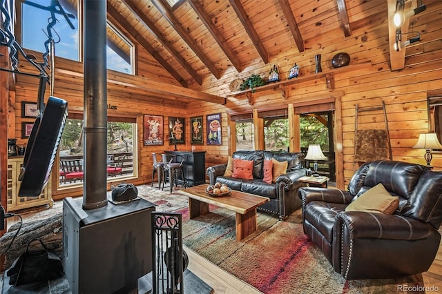 1673 Sinton Rd, Evergreen, CO 80439 - living area with wood ceiling with exposed beams, healthy amount of natural light, wood walls, high vaulted ceiling, and wood finished floors