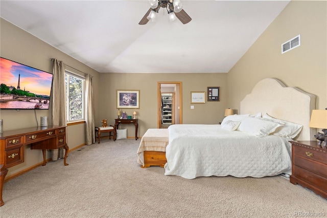 carpeted bedroom with ceiling fan and vaulted ceiling