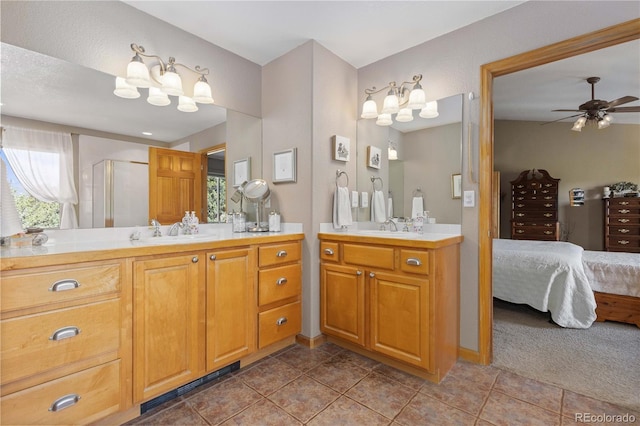 bathroom featuring a shower with door, vanity, tile patterned floors, and ceiling fan