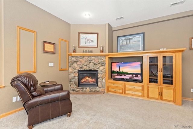 carpeted living room with a fireplace