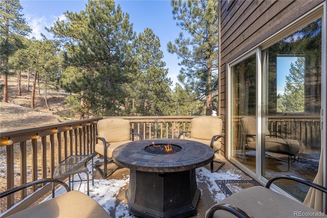 wooden deck featuring a fire pit