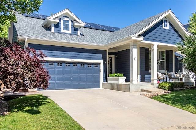 1038 Mircos St, Erie, CO 80516 - view of front of property featuring a porch, roof mounted solar panels, roof with shingles, and driveway