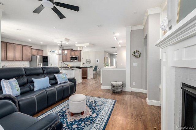 1038 Mircos St, Erie, CO 80516 - living room with ceiling fan, a fireplace, light wood-style floors, and recessed lighting