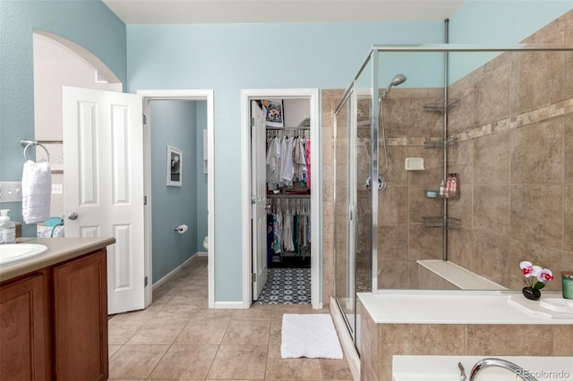 1038 Mircos St, Erie, CO 80516 - full bath featuring vanity, a stall shower, tile patterned flooring, a spacious closet, and a bath